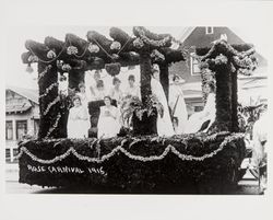 Rose Carnival float holding women in white with live doves