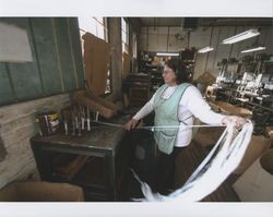 Maria Estella Sanchez pulling material off bobbins at Sunset Line & Twine Company in Petaluma, California, Dec. 5, 2006