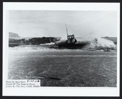 Tug and barge making their way out to sea via the mouth of the Russian River