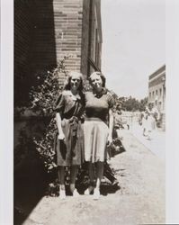 Mary McGregor and an unidentified woman standing in front of a building at Santa Rosa High School, Santa Rosa, California, about 1941