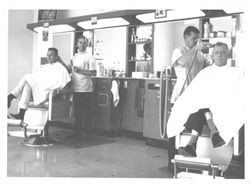 Men getting a haircut at an unidentified barbershop, Petaluma, California, about 1965