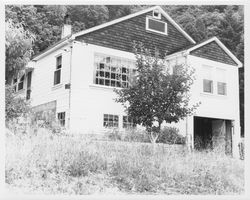 Unidentified two-story house with a first-story garage and entrance on the left side, 1960s or 1970s