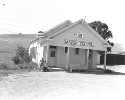 Man standing next to the porch of Marin School