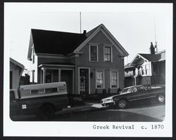 Two story "L" shaped Greek Revival house with roof returns