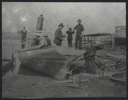 Men with tools building a boat