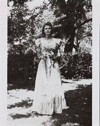 Mary McGregor holding flowers and wearing her school graduation dress, Santa Rosa, California, 1941