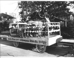 Gordon Olson as Santa seated behind the wheel of his "sleigh" which is parked in front of the Tomasini home at 625 D Street, Petaluma, California in 1936