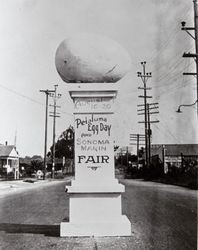 Egg topped pillar with the words painted on, "August 16-20 Petaluma Egg Day and Sonoma-Marin Fair Petaluma, California, 1930s