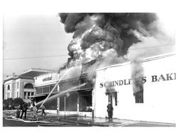 Send water onto roof of the burning Rex Hardware building, Petaluma, California, Jun. 21, 1942