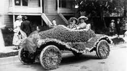 Roadster decorated for the Rose Parade complete with a Kewpie doll hood ornament