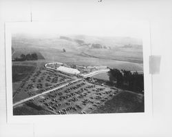 Aerial view of parked cars and a large tent at the Western Sonoma-Marin Dairy Cattle Show, Valley Ford, California, 1924