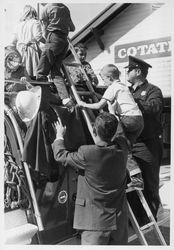 Cotati (California) Fire Department members showing children a fire engine, about 1963