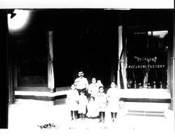 Family outside the Petaluma Macaroni Factory, Petaluma, California, 1907