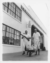 John M. Ferina and Harry R. Wright Push a Wheelbarrow Full of Silver Dollars