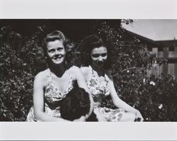 Mary McGregor and an unidentified girl sitting with a dog, about 1938