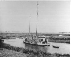 Scow loade with bales of hay