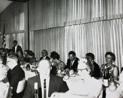 Gene Benedetti, Jack W. Dei, Sr. and Mary Dei seat at an unidentified dairy council dinner