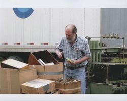 John Agnew outside at Sunset Line & Twine Company building in Petaluma, California, sorting through boxes on Dec. 8, 2006