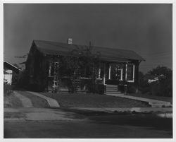 Shingle-sided bungalow home with detached garage on an unidentified street in Sonoma County, California, 1940s or 1950s