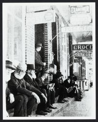 Group of men sitting on front steps of the Post Office