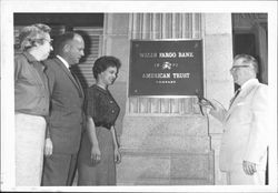 Changing name plate on bank, Petaluma, California, 1962