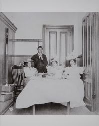 Stephen Henderson Akers and three unidentified women seated at a table, about 1892