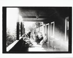 People sitting on the porch of the Glen Rita Hotel