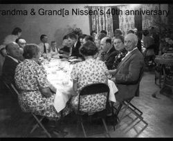 Nissen family gathered at the dinner table for Jacob and Susana Nissens' 40th anniversary in Petaluma, California, 1939