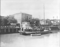 Oil drums being unloaded from Osborn and Bornholdt Firefighting barge