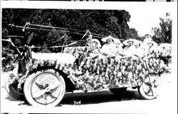 Six women in a roadster decorated with flowers, streamers and a large set of antlers, Petaluma