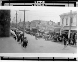 View of parked cars and crowds on Main Street at Washington, looking south, Petaluma