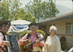 Helen Putnam with strolling musicians at County Fair Board luncheon, Santa Rosa, California, 1979