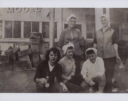 Girl friends pose by a store selling beer and tobacco, Petaluma, California, in the 1940s