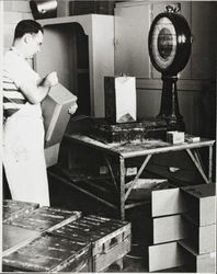 Unidentified man shown weighing cheese at the Petaluma Cooperative Creamery, about 1955