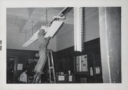 Changing light fixtures in the Carnegie Library, Santa Rosa