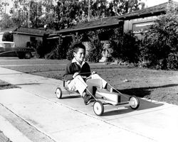 Child riding a Ram Rod Coaster, Santa Rosa, California, 1958