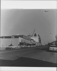 Bank of America's Petaluma, California branch at the corner of Washington and Main Streets, with crane at the new bank construction site at 200 Kentucky Street, March 1969