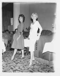 Two models in evening dresses in the "Dramatic Moods" fashion show in the Topaz Room, Santa Rosa, California, 1959