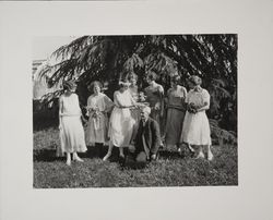 Girls placing garland on Luther Burbank's head