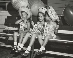 Three little girls enjoy popcorn at the Sonoma County Fair, Santa Rosa, California, 1957