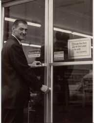 George Tomasini locking up the door to his hardware store in Petaluma, California, on closing day in 1967
