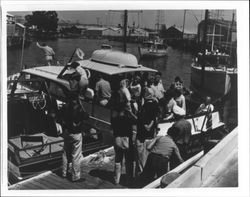 Docking a crowded pleasure boat, Petaluma, California, 1958