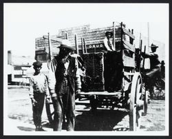 Men loading a wagon on the southeast corner of West Street and Broad Street, Cloverdale, 1900?