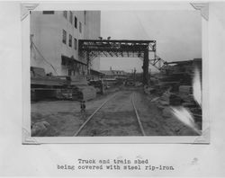 Truck and train shed at the Poultry Producers of Central California feed mill, Petaluma, California, being covered with steep rip-iron, 1938