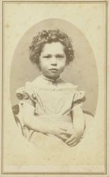 Portrait of an unidentified young girl with curls and a checked dress