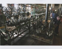 Russell Strickland checking a braiding machine on a pallet at Sunset Line & Twine Company in Petaluma, California, Dec. 2006