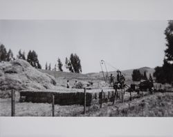 Farmhands and hay baler on the Volkerts ranch and dairy, Two Rock, California, 1940s