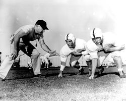 Coach Bill Abbey with football players