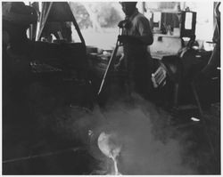 Foundry worker pouring molten metal at an unidentified shop, 1940s or 1950s