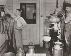 Two men with a DeLaval milk separator